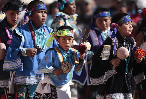 YOUNG PEOPLE TAKE PART IN FESTIVAL ON ZUNI PUEBLO INDIAN RESERVATION IN NEW MEXICO